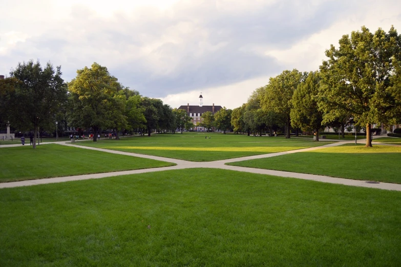 a park filled with lots of green grass and trees, academic art, sunken square, centered and symmetrical, dusk setting, cross