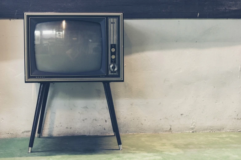 a black and white television sitting on top of a wooden stand, by Carey Morris, pixabay, modernism, facebook post, texture, professional comercial vibe, in retro colors