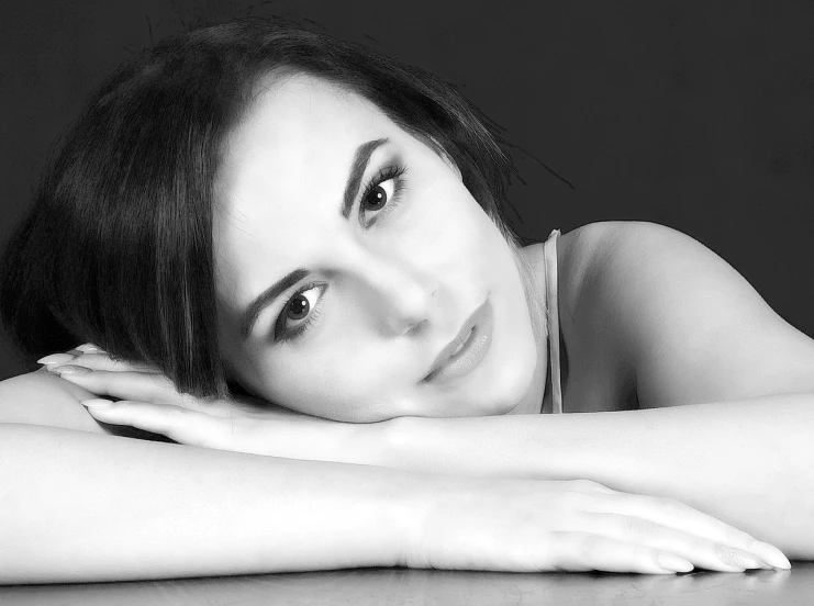 a black and white photo of a beautiful woman, a black and white photo, by Antoni Brodowski, trending on pixabay, relaxing and smiling at camera, ana de la reguera portrait, laying down, classical portrait