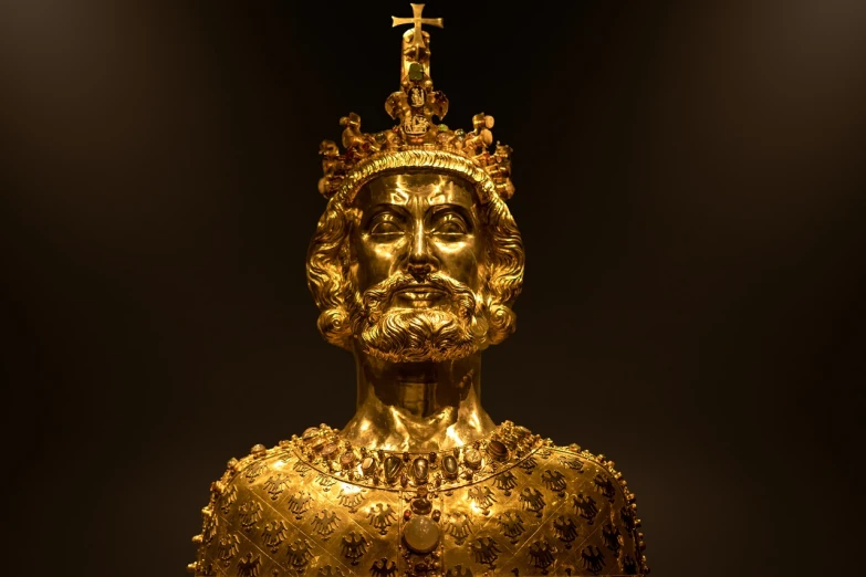 a gold statue of a man with a crown on his head, by Juergen von Huendeberg, treasures of gold, beard, sleek, king arthur