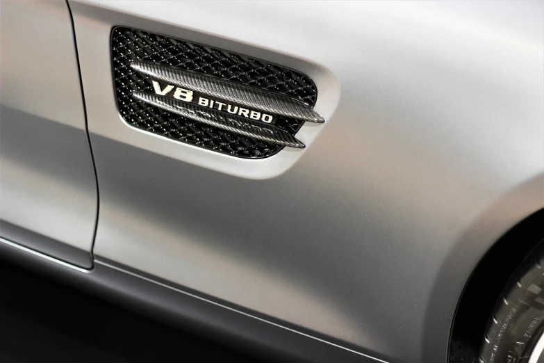 a close up of the front of a silver car, vtmb, turbo, carbon fiber, embossed