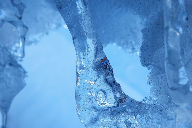 a group of ice sculptures sitting on top of a snow covered ground, a macro photograph, dripping saliva, blue image, up-close, water pipe