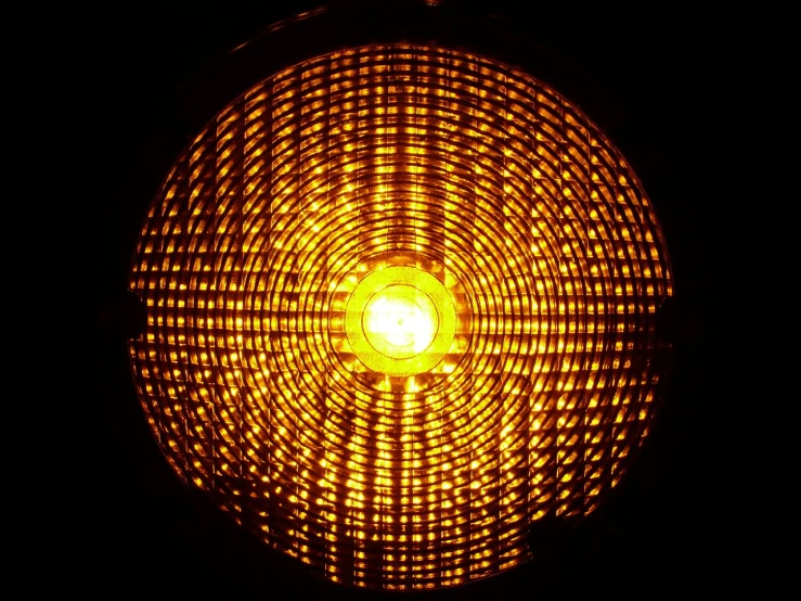 a close up of a light in a dark room, by Jon Coffelt, flickr, warning lights, on a reflective gold plate, woven with electricity, radial light