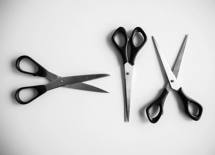 a pair of scissors sitting next to each other, a black and white photo, by Alexander Fedosav, pexels, minimalism, four, cuts, ron cobb, dan mumfor