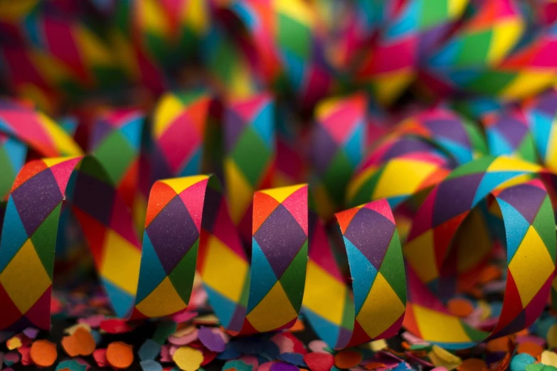 colorful ribbons and confetti sprinkles on a table, inspired by Bernd Fasching, pexels, neo-fauvism, bangles, faceted, macro art, jester