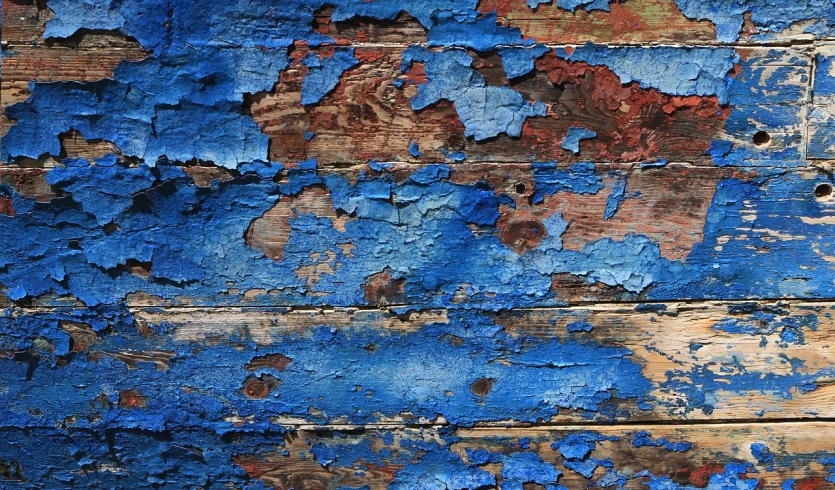 a close up of peeling paint on a wooden surface, a detailed painting, inspired by Richter, pixabay, deep blue mood, detiled, subtle wear - and - tear, multi - coloured