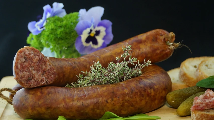 a bunch of sausages sitting on top of a cutting board, a portrait, pixabay, hurufiyya, herbs, 🌸 🌼 💮, chorizo sausage, moss