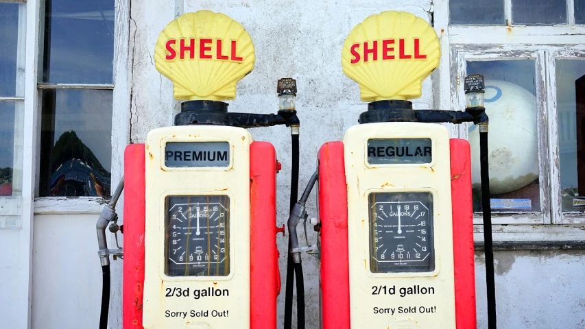 a couple of gas pumps sitting next to each other, pixabay, fine art, shells, 1 9 7 5 photo, ad image, sheild