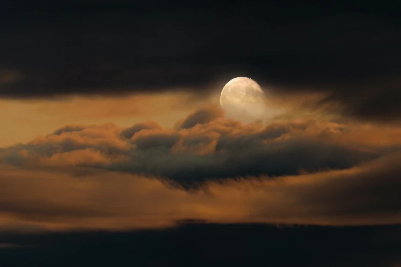 a full moon is seen through the clouds, by Linda Sutton, flickr, romanticism, golden clouds, national geographic photo”, victor antonov, large moon