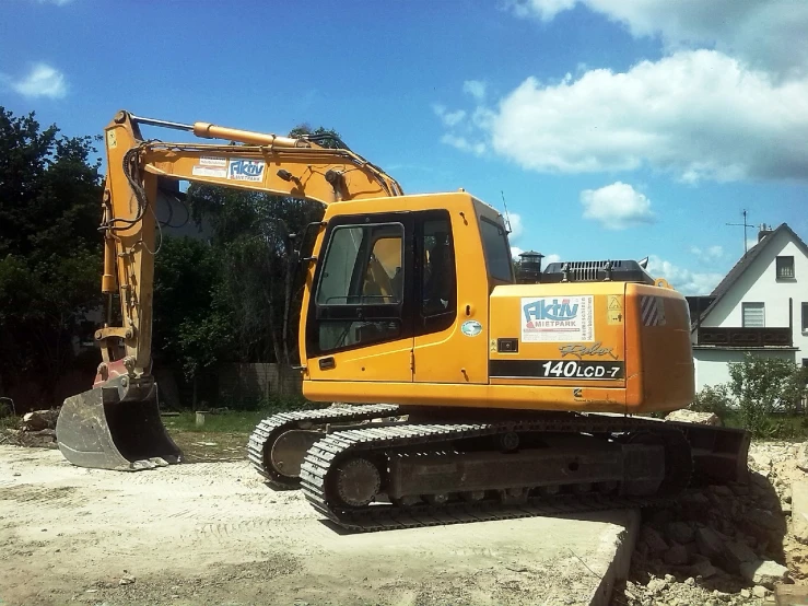 a yellow excavator sitting on top of a pile of dirt, a photo, flickr, hurufiyya, ah puch, 240p, ready to fly, 4 0 0 mm