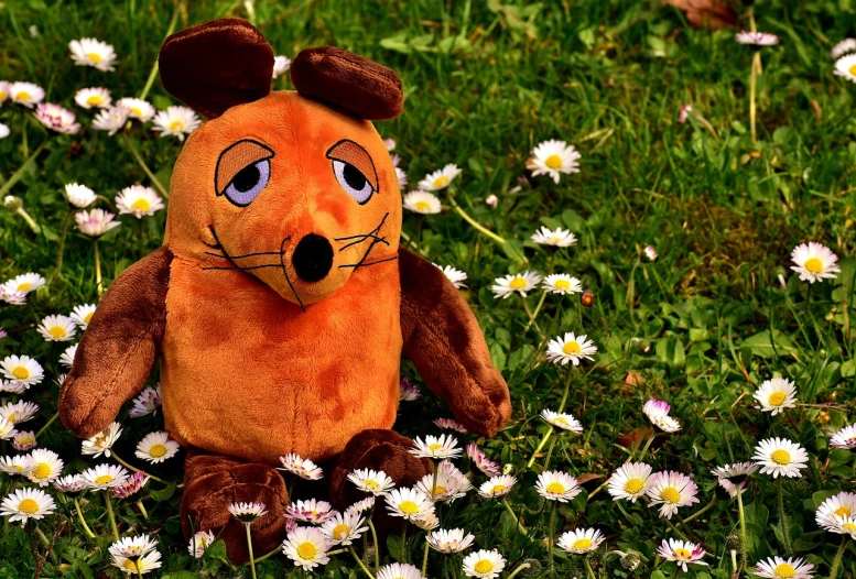 a stuffed animal sitting in a field of daisies, a cartoon, by Tom Carapic, pixabay contest winner, anthropomorphic beaver, fuzzy orange puppet, mouse body, dystopian toy