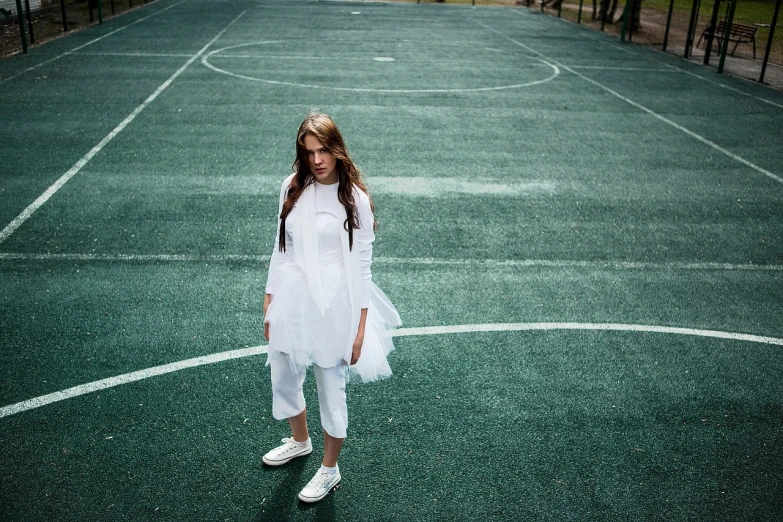 a young girl standing on top of a tennis court, inspired by Elsa Bleda, pexels contest winner, bauhaus, white tunic, nun fashion model, girl with super long hair, white shoes