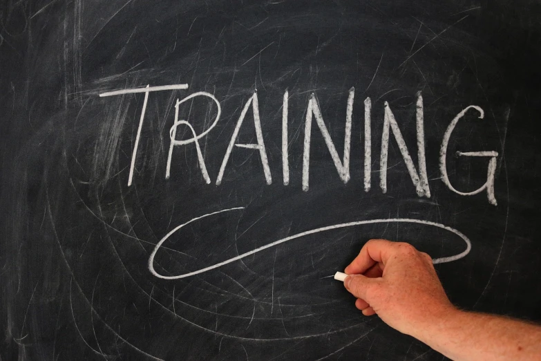 a person writing training on a blackboard, pixabay, emergency, training, very ornate, overhead