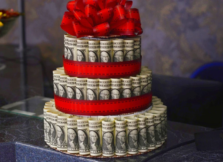 a stack of money sitting on top of a table, the greatest cake, ffffound, holiday season, celebrating a birthday