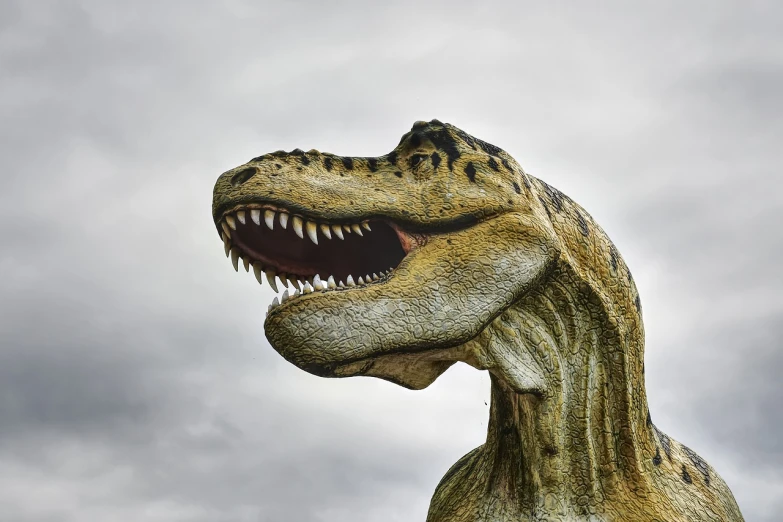 a statue of a dinosaur with its mouth open, a statue, inspired by Adam Rex, pixabay, realism, profile close-up view, flash photo, the creature sells a used car, highly textured