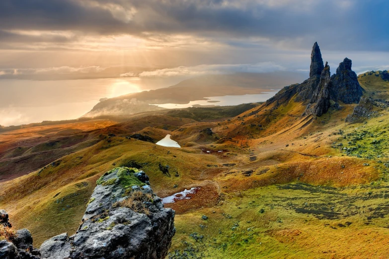 a person standing on top of a mountain next to a body of water, by Alexander Robertson, pixabay contest winner, romanticism, scottish style, golden hues, farming, detailed scenic view