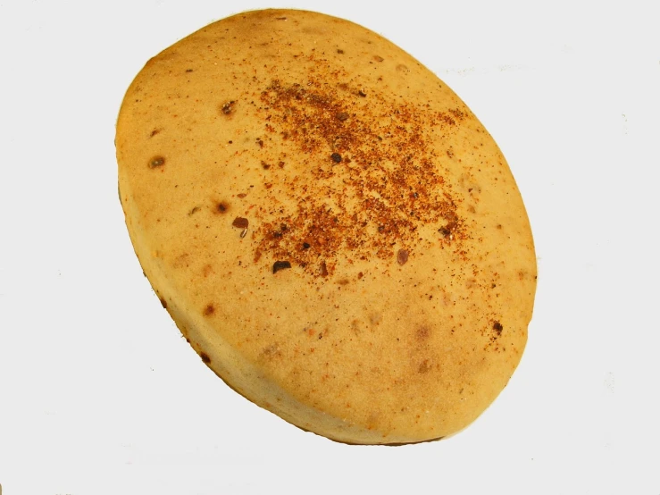 a close up of a pancake on a white surface, flickr, ethiopian, close-up product photo, bun ), spicy