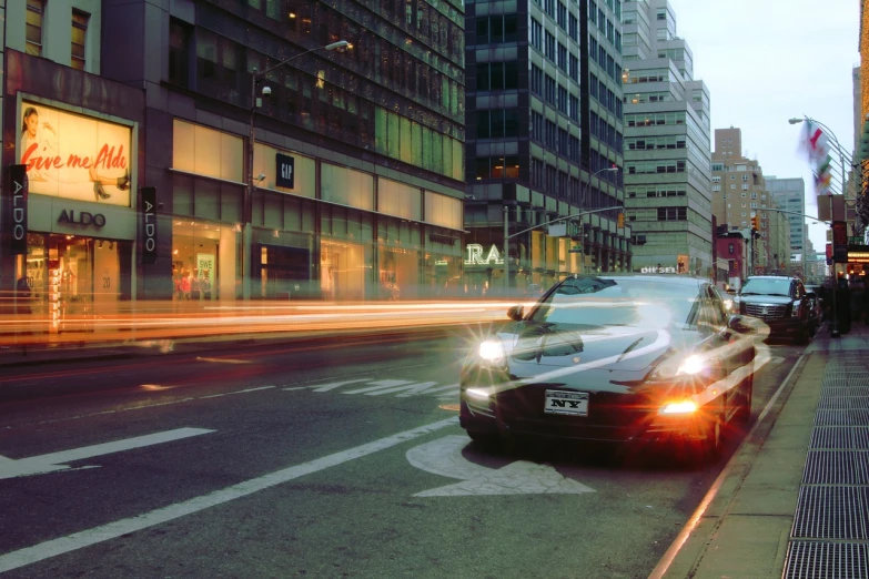 car passing down a busy city street in traffic