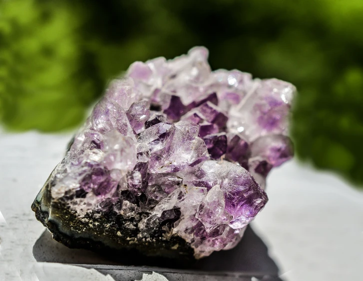 aite crystals resting on top of a piece of metal