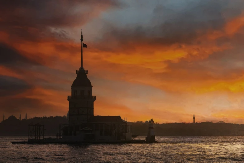 a clock tower is on top of a building in the water