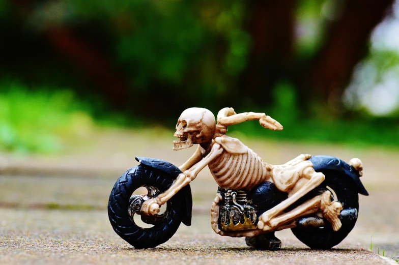 a figurine that has been placed on top of a motorcycle