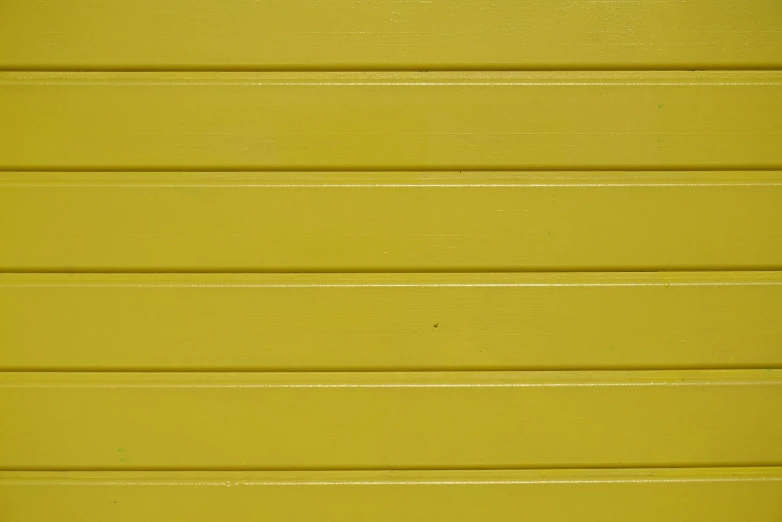 yellow painted wooden siding with a red stop sign