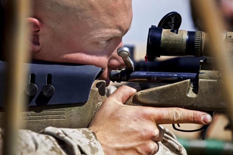 an army man holding a toy gun to another person's ear