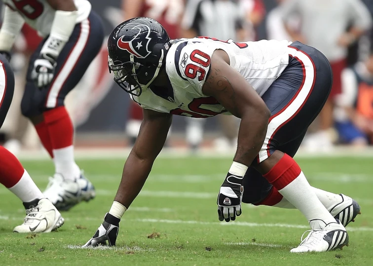 a football player squatting on the field