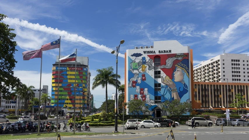 a street corner with palm trees, cars and buildings