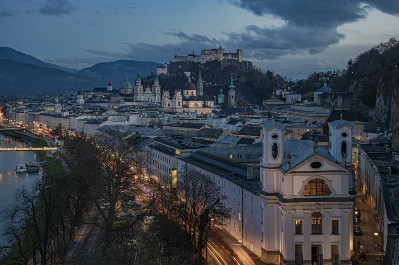 a large castle overlooking a city with lots of traffic