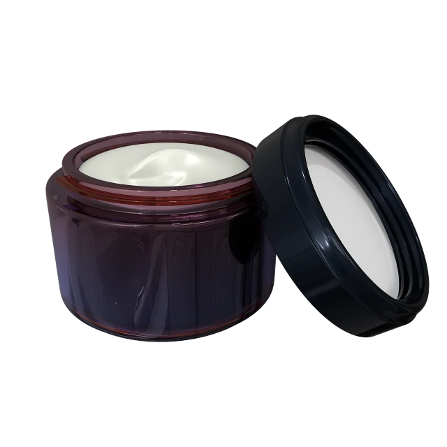 a container with a lid, with a black lid and a white bowl of cream inside it