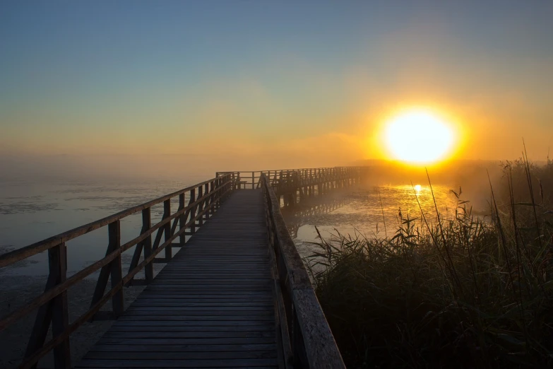 a wooden walkway going down to a small beach