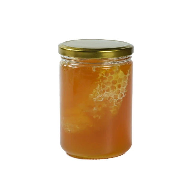 a jar full of honey with a golden lid