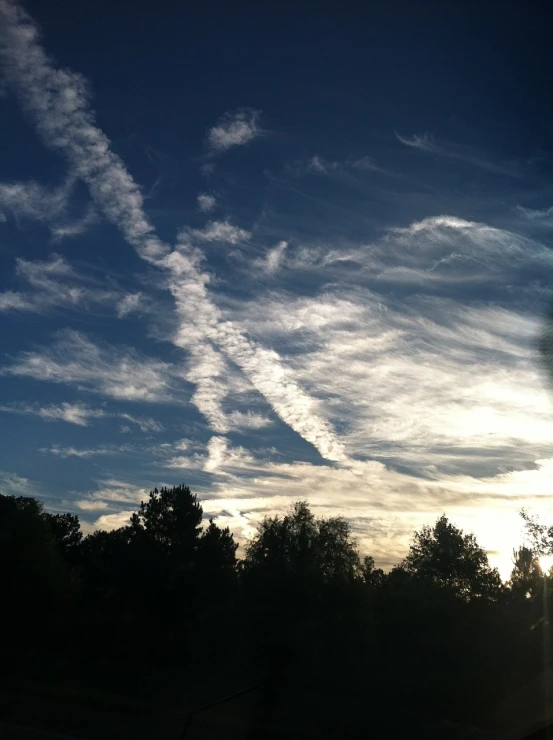 two planes flying through a cloudy blue sky