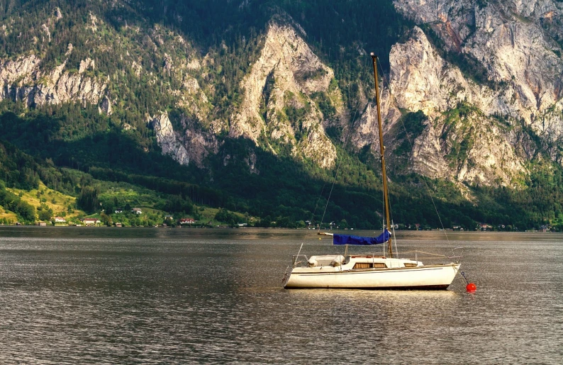 an image of a small sailboat in the middle of the water