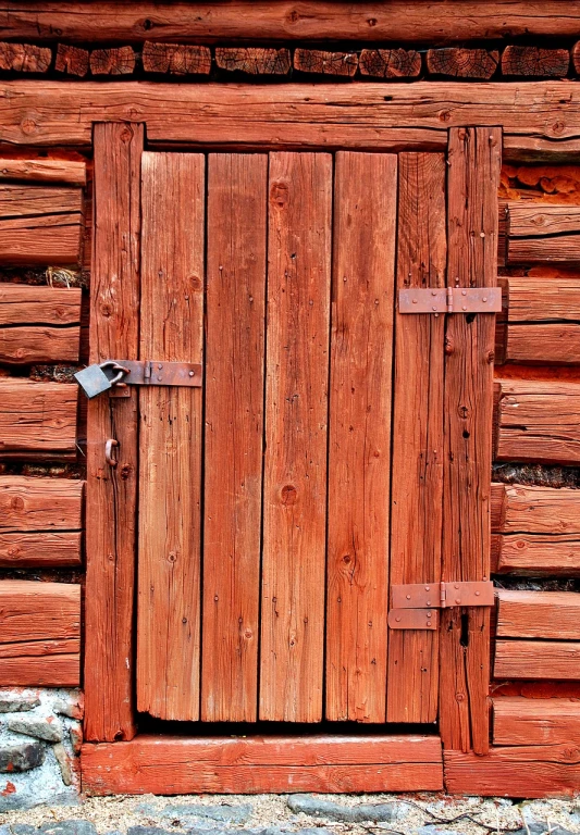 a close up view of the wooden door of a small wooden building