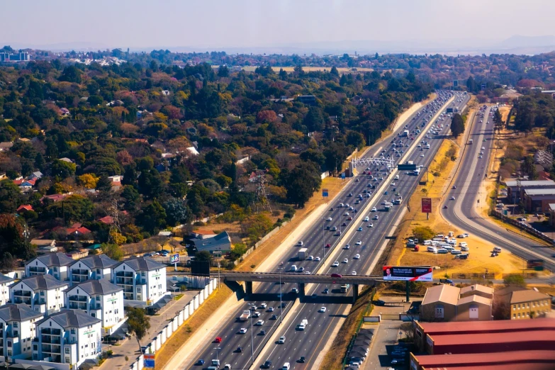 an aerial s of highway and homes in the distance