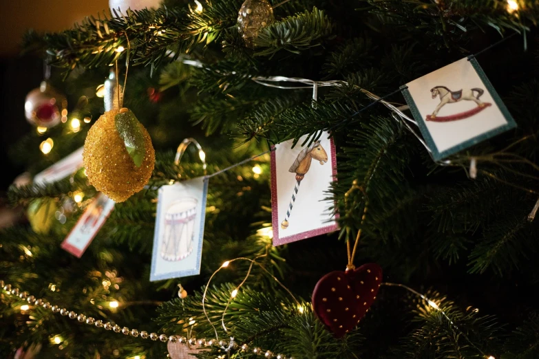 there are cards hanging on the christmas tree