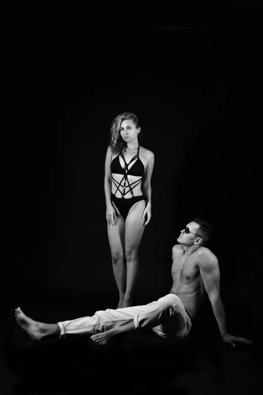 a man standing next to a woman on top of a man