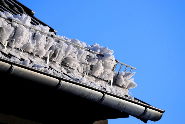 a black roof with lots of snow on it