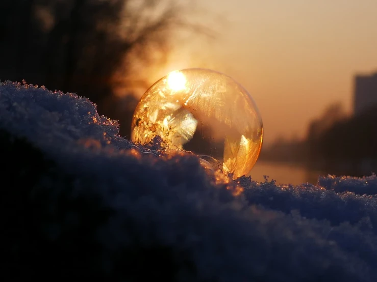 close up of the sun's reflection through a frozen bubble