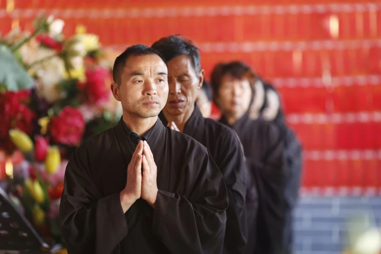 the man standing in front of the woman is meditating