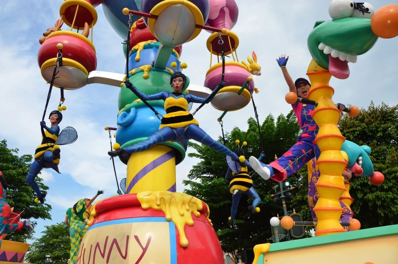 a group of people riding on top of a colorful float