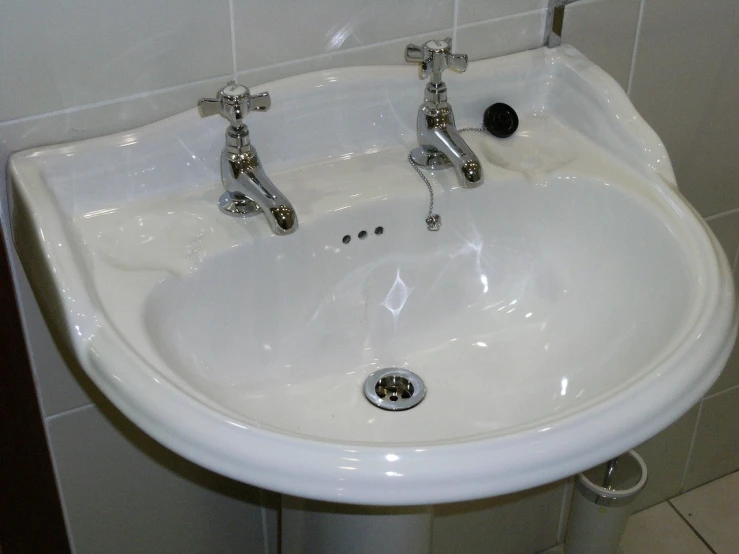 a sink is shown against the wall and tile