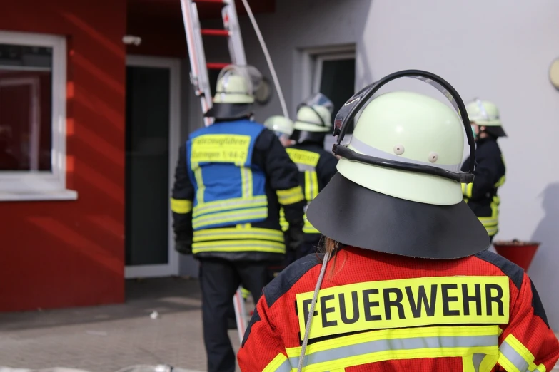 some people in construction uniforms outside of a building