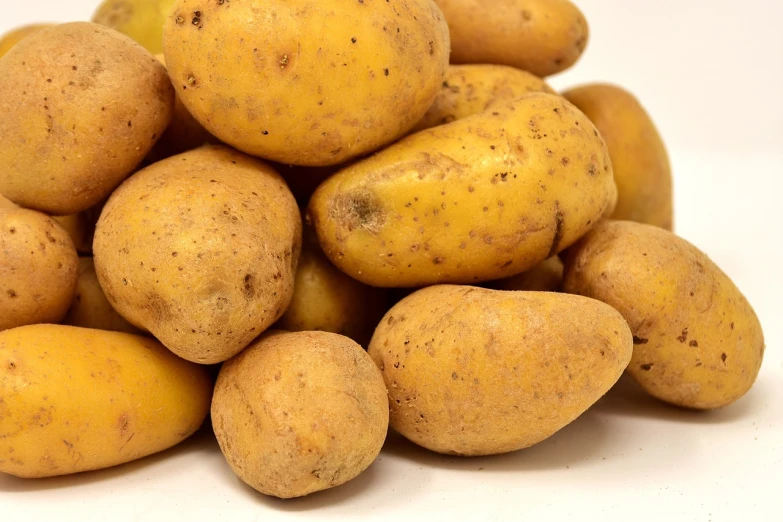 a pile of potato sitting on top of white ground