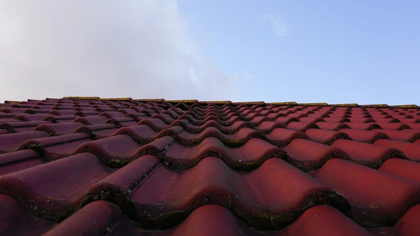 a very pretty red tiled roof against a clear blue sky