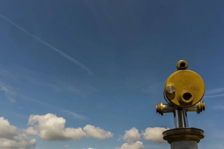 a telescope sits atop the top of a monument