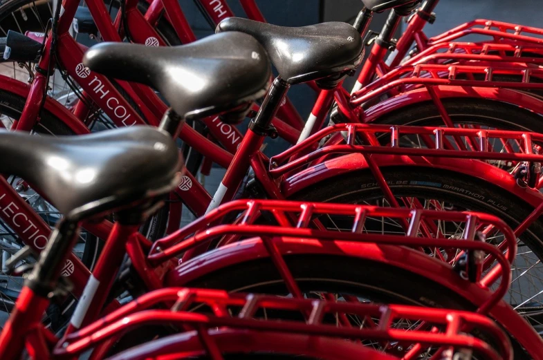 a row of bicycles with a red back