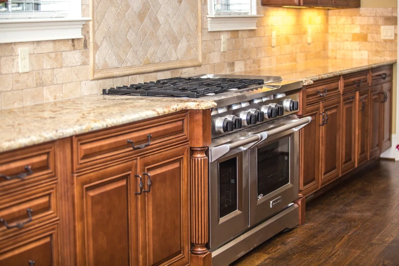 a kitchen has an oven with a wooden counter top